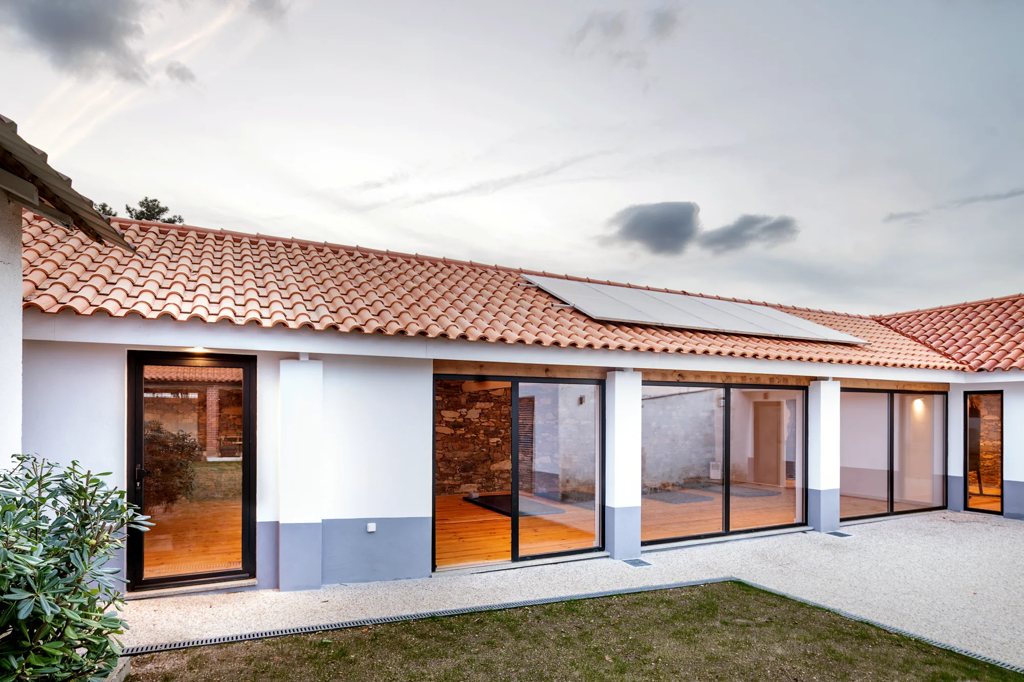 Glass-fronted studio opening onto the courtyard