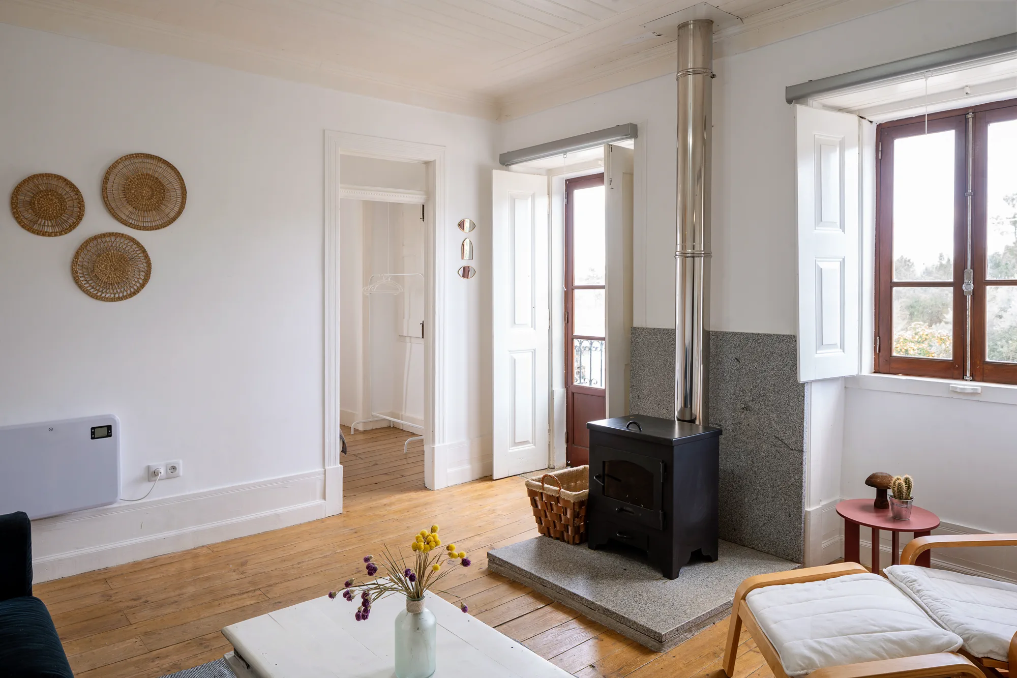 Farmhouse lounge corner with stove and reading chairs